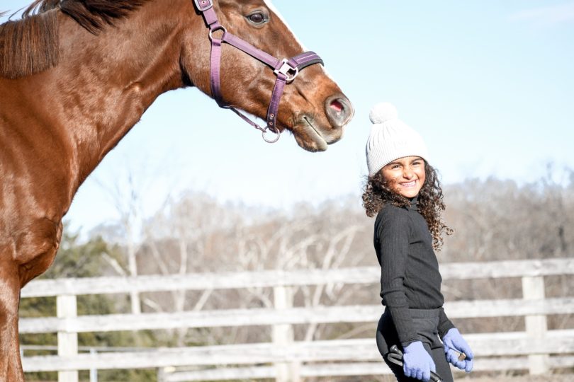 child bonding with horse