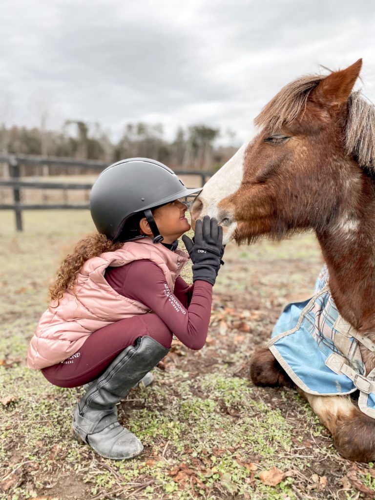 girl kissing pony