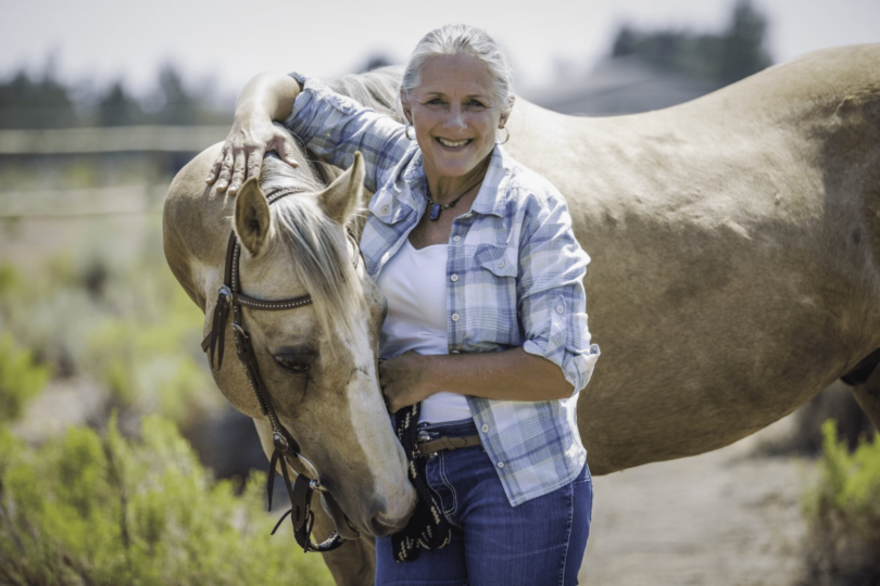 woman and palomino horse