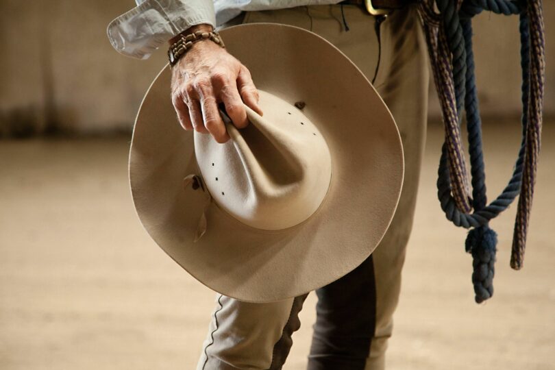 cowboy holding cowboy hat