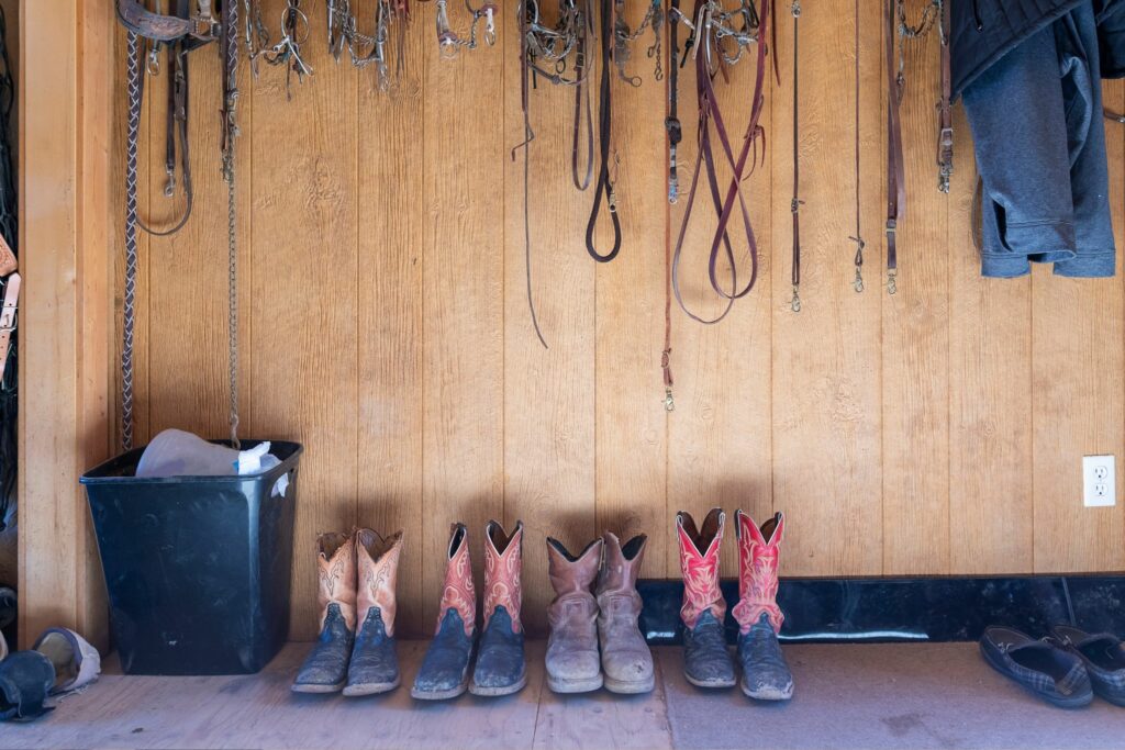 cowboy boots along tack room wall