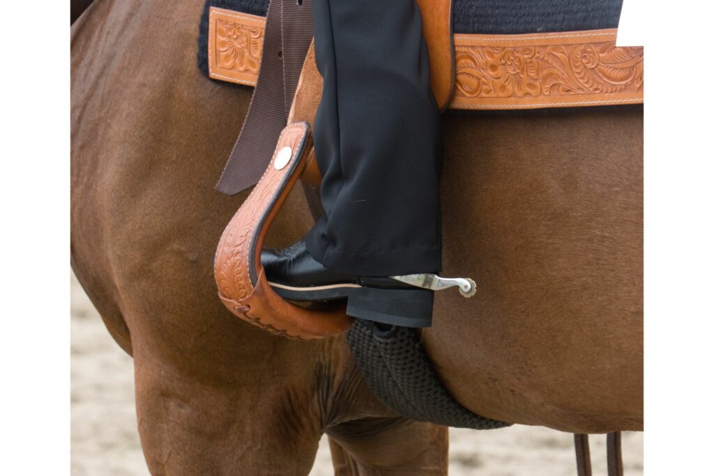 Western rider using spurs with show tack