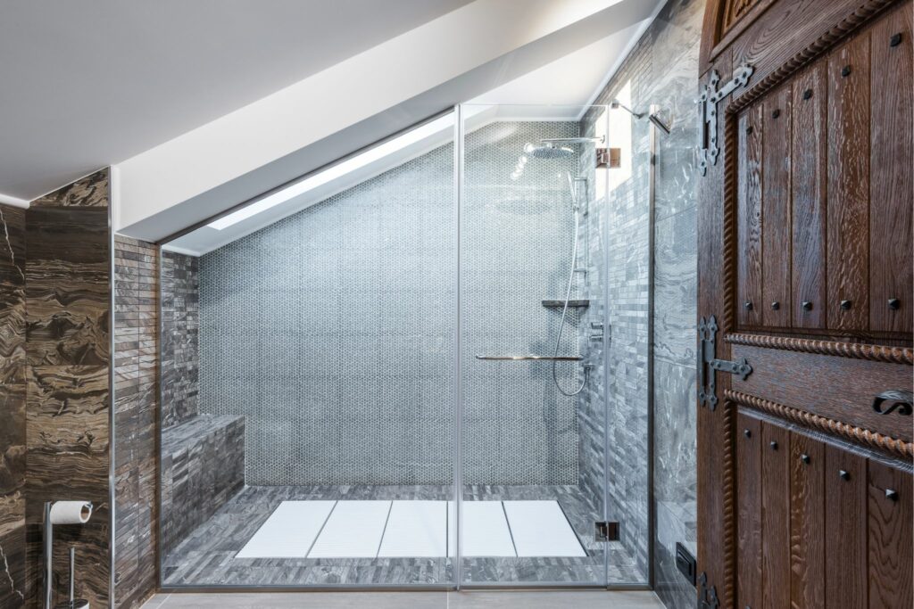 stone shower with antique wood cabinetry