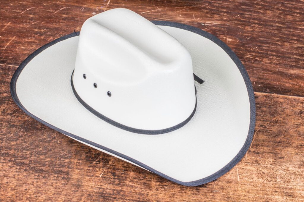 straw cowboy hat on wood background