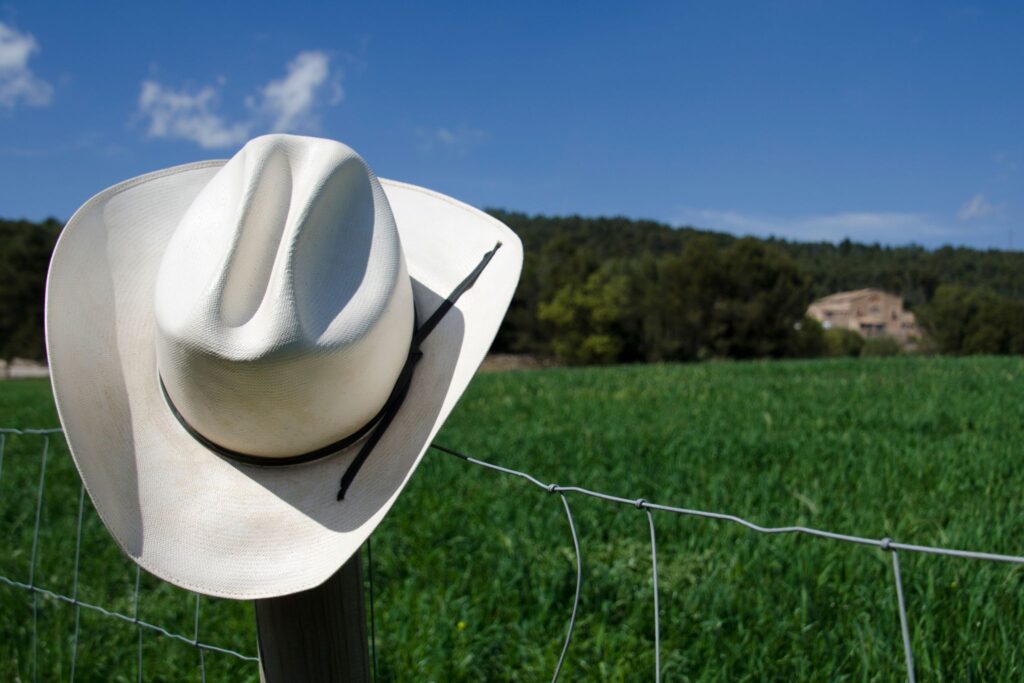 straw cowboy hat on fencepost