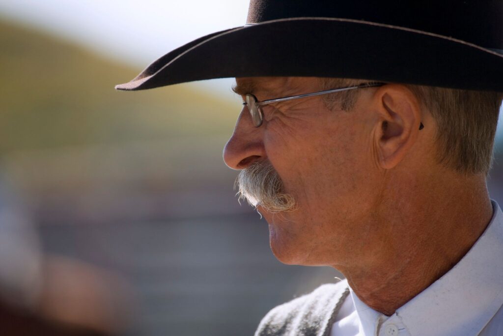man with glasses and cowboy hat