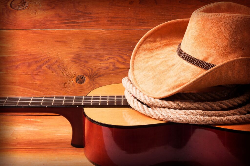 hat sitting on rope and guitar