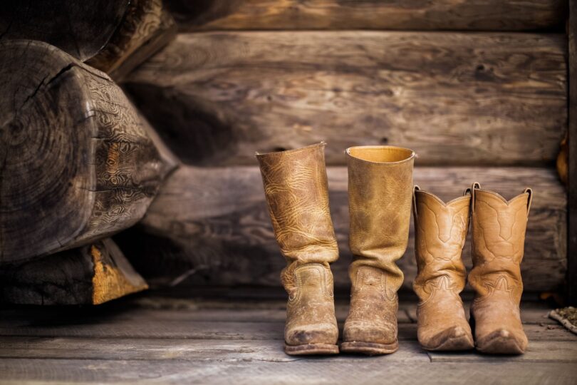 tall and short boots next to each other on floor