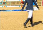 person walking a jump course