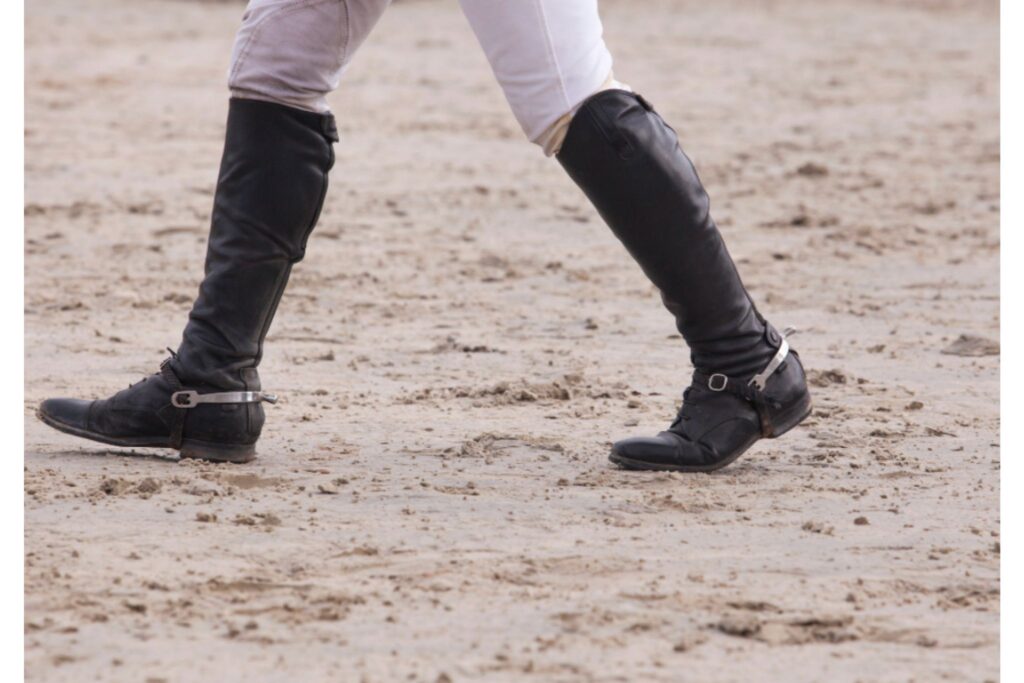 person walking jump course in tall boots
