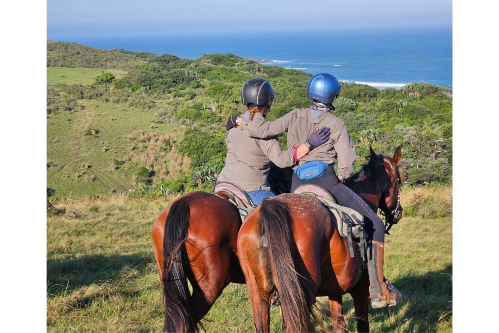 two riders hug on horseback